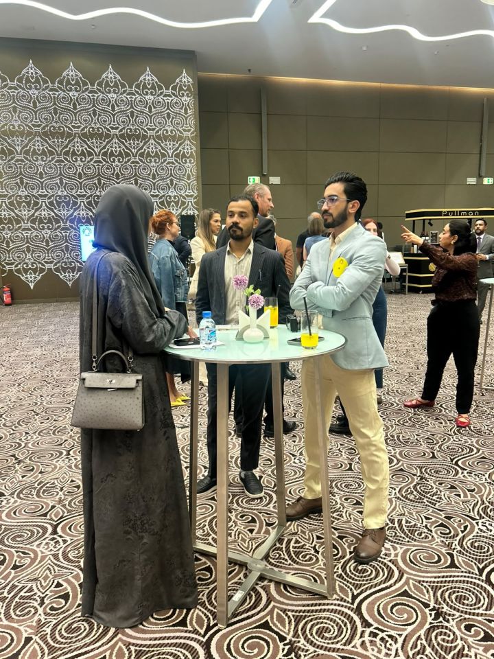 Standing-table discussion with attendees at the Back to Business networking event in Qatar