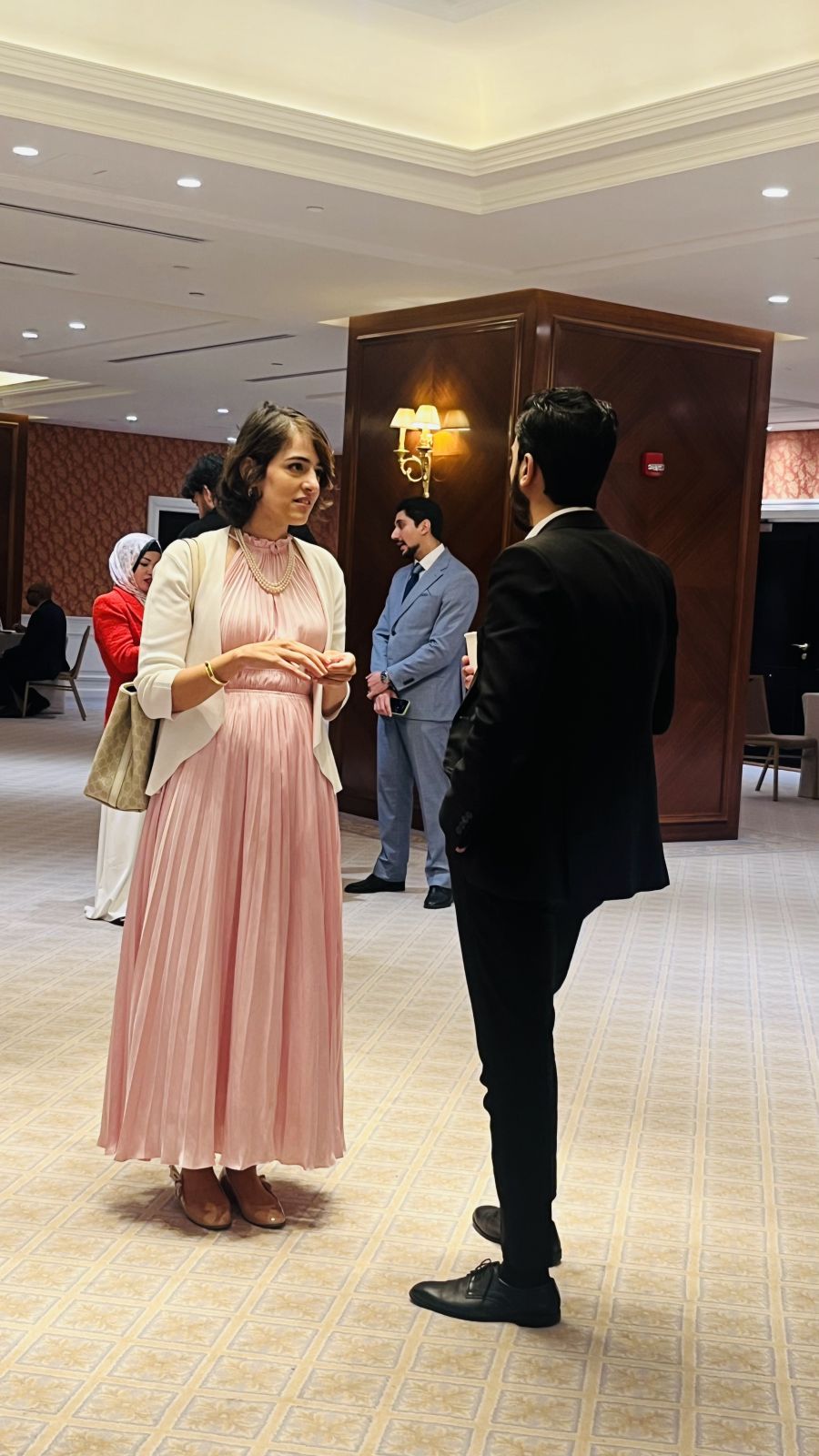 Two attendees in conversation during the QDB Networking Event at The Plaza Ballroom, Qatar